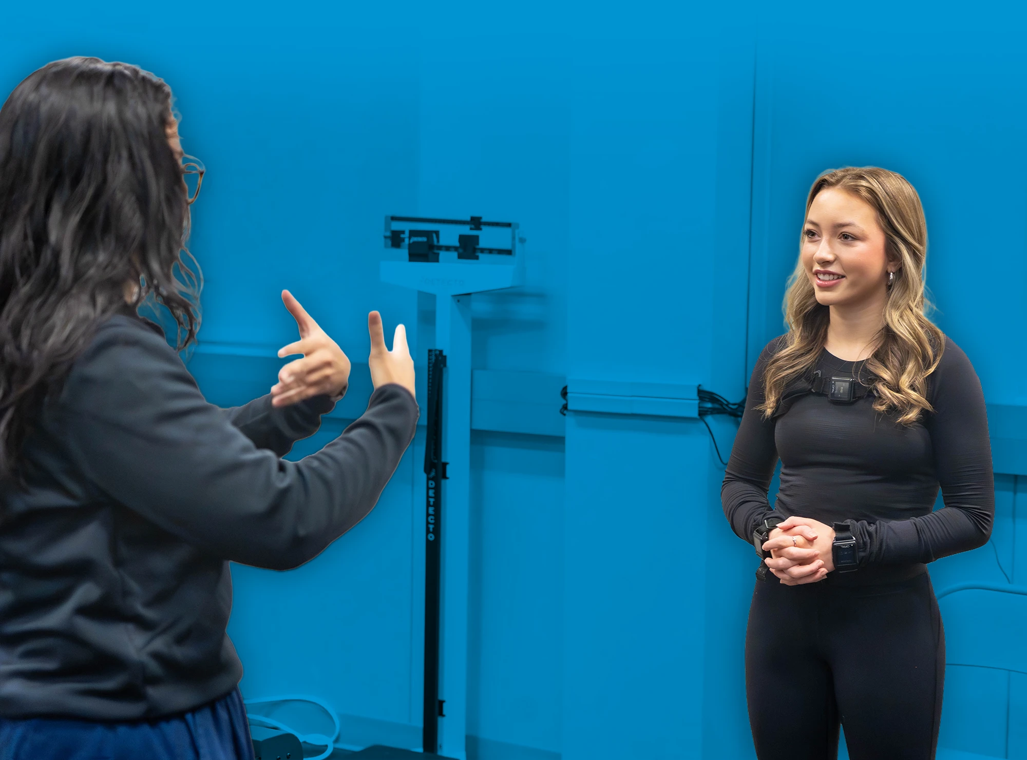 Eva Litkenhous listens as an Auburn researcher explains a Parkinson’s disease research procedure in the Locomotor Lab.