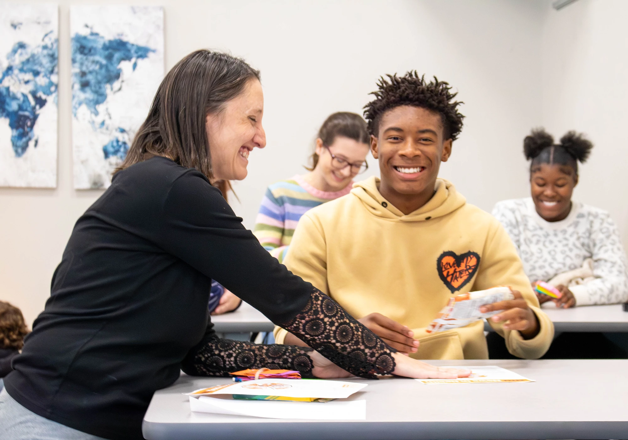 Assistant Professor Tierney Hinman smiles with Beauregard High School students during a literacy initiative activity.