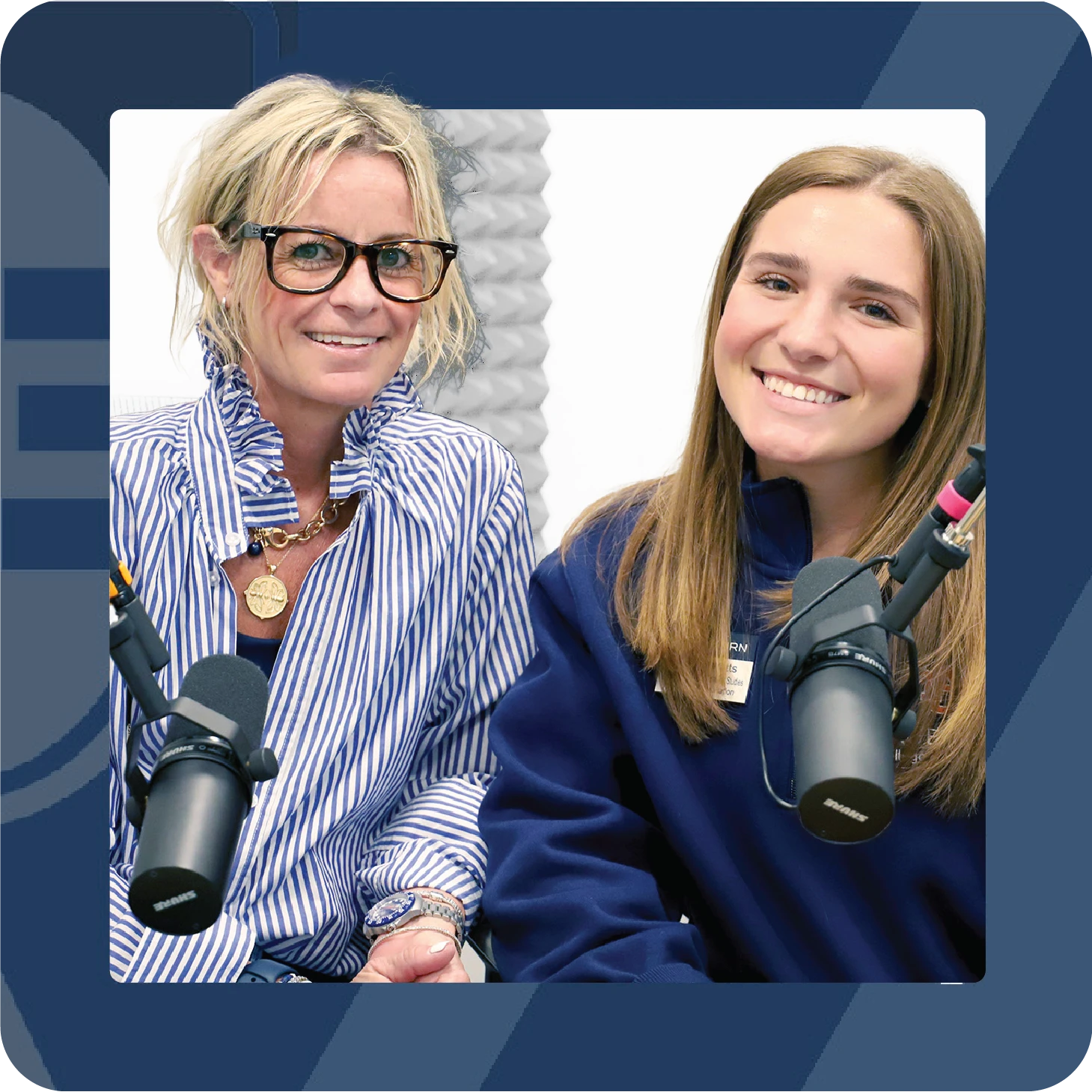 Two women smile in a podcast studio while seated beside microphones, framed within a blue graphic layout.