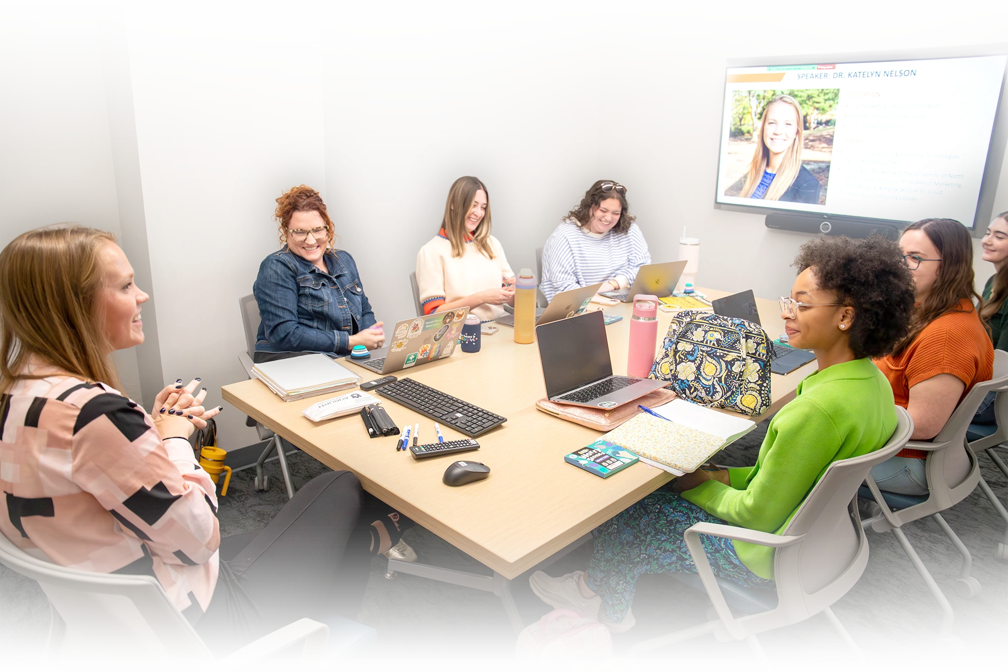 counseling-secondary-02.webp Alt text description: Group of students sit around a conference table with laptops and notebooks during a class discussion.
